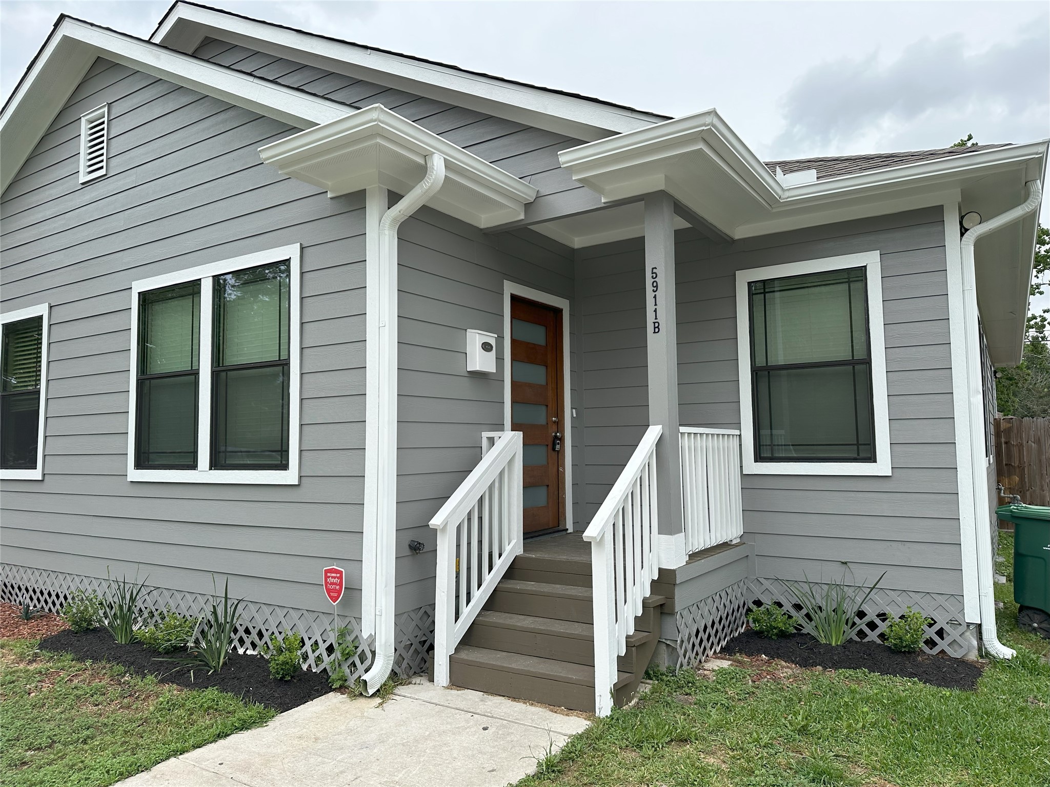 5911 Westover Street, Unit B Houston, TX 77033 - Photo 3 of 21 a view of a house with stairs and a yard