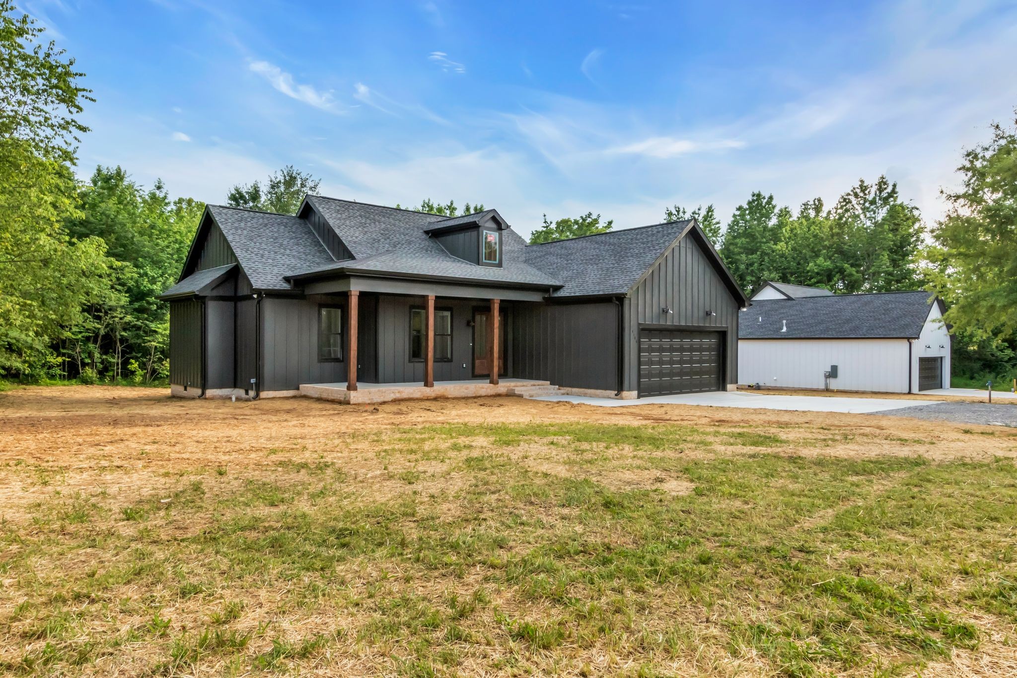 4106 Asbury Road Manchester, TN 37355 - Photo 4 of 58 a front view of a house with a garden and yard