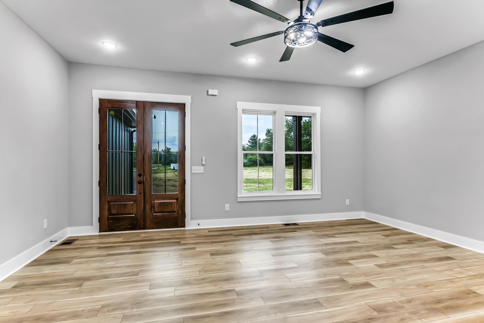4106 Asbury Road Manchester, TN 37355 - Photo 6 of 58 a view of an empty room with window and wooden floor