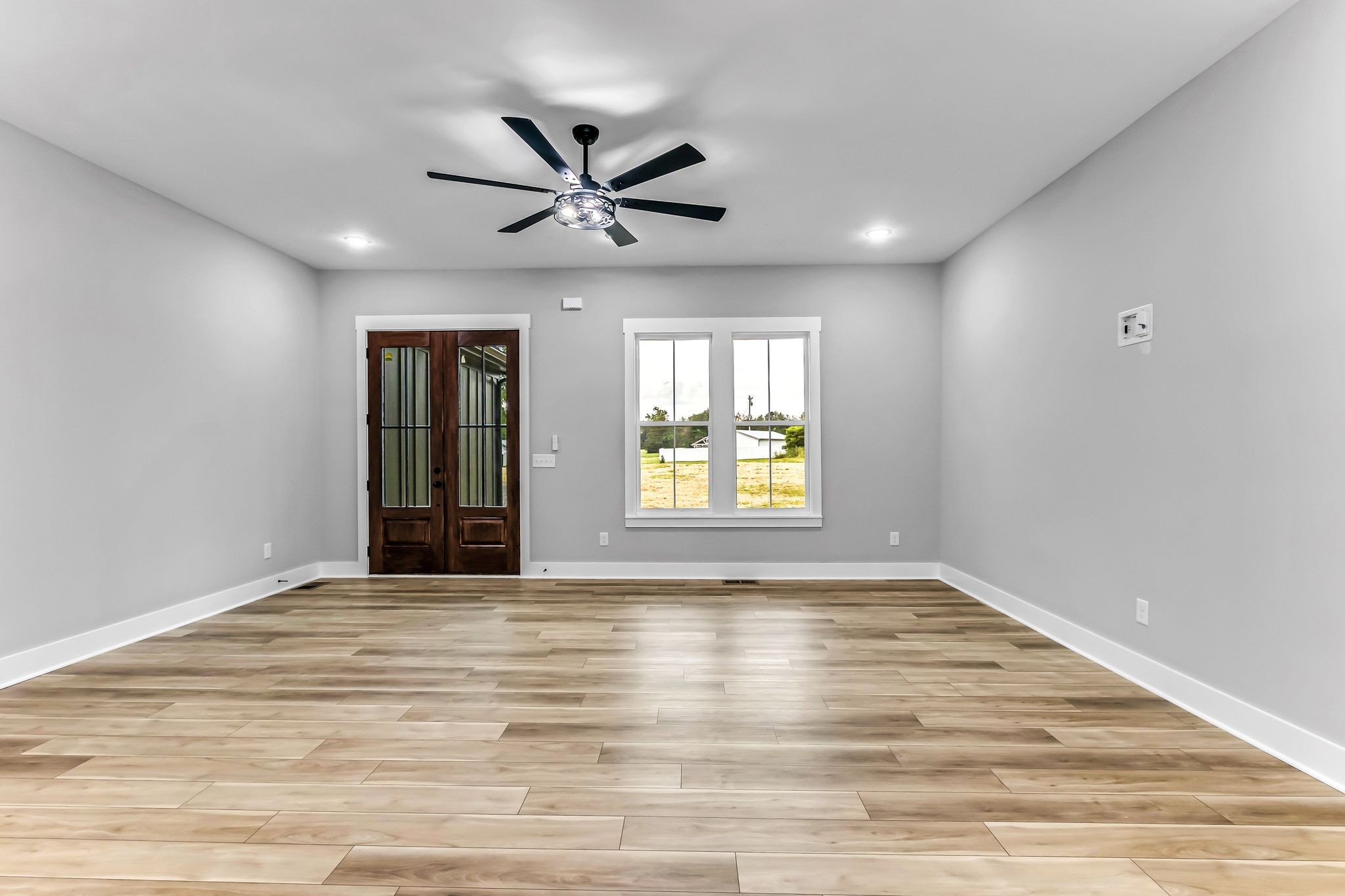 4106 Asbury Road Manchester, TN 37355 - Photo 7 of 58 a view of an empty room with window and wooden floor