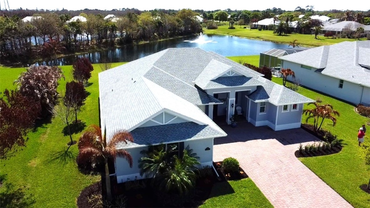 105 Night Hawk Way Sebastian, FL 32958 - Photo 1 of 36 a view of a lake with a house in the background