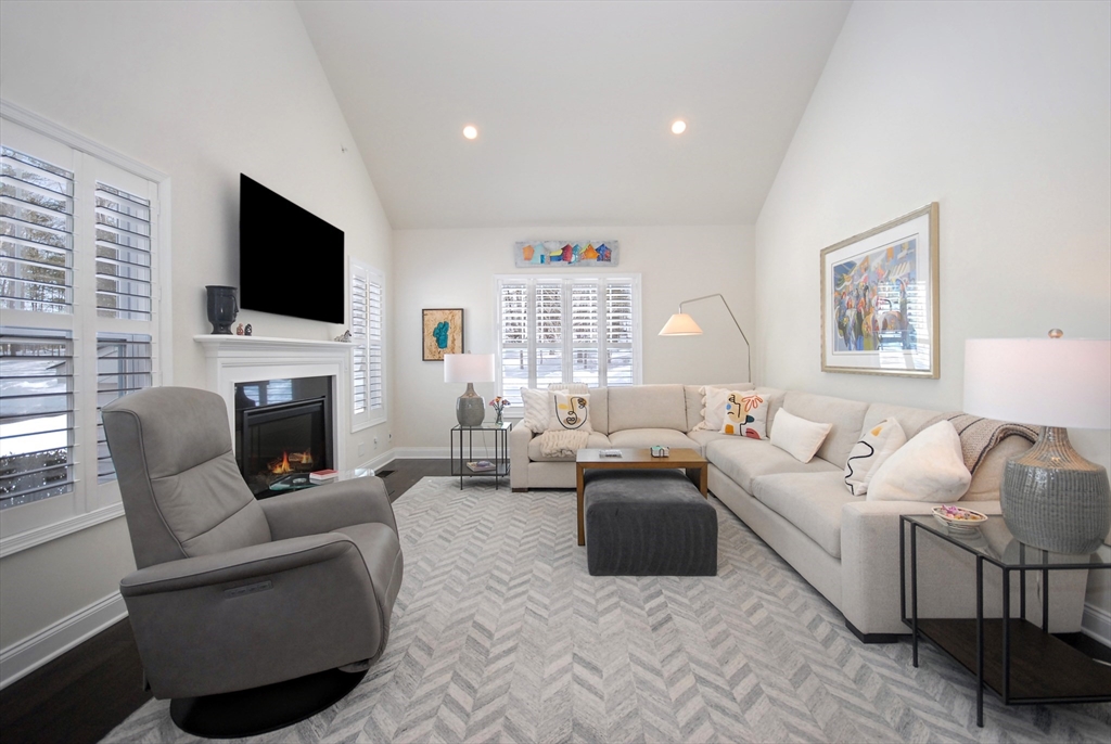 39 Ridgewood Drive, Unit 39 Stow, MA 01775 - Photo 1 of 26 a living room with furniture fireplace and a flat screen tv