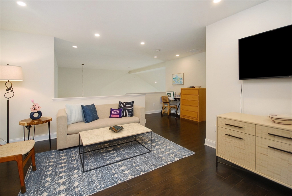 39 Ridgewood Drive, Unit 39 Stow, MA 01775 - Photo 14 of 26 a living room with furniture and a flat screen tv