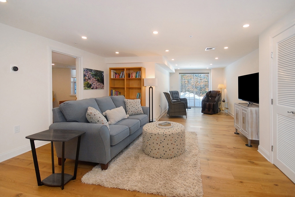39 Ridgewood Drive, Unit 39 Stow, MA 01775 - Photo 18 of 26 a living room with furniture and a flat screen tv