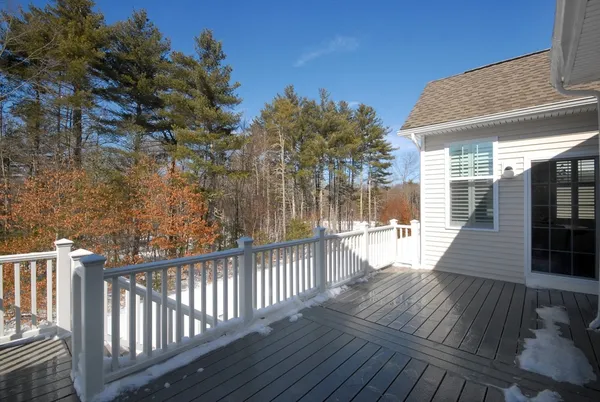 a view of a house with wooden deck