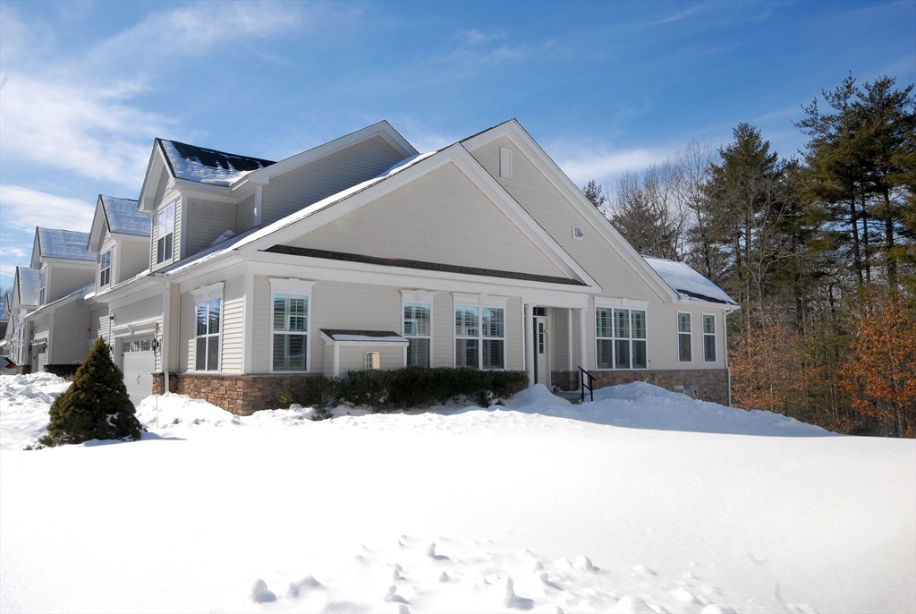 39 Ridgewood Drive, Unit 39 Stow, MA 01775 - Photo 25 of 26 a view of a house with a yard covered in snow