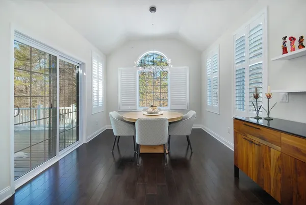 a view of a dining room with furniture window and wooden floor