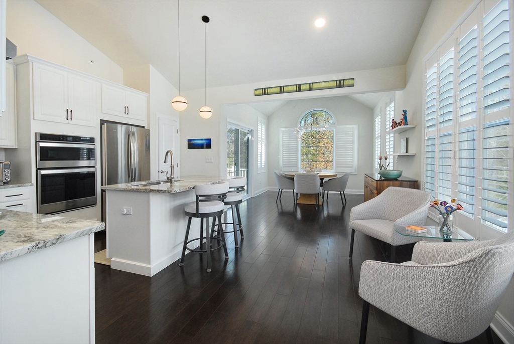 39 Ridgewood Drive, Unit 39 Stow, MA 01775 - Photo 6 of 26 a living room with fireplace furniture and a wooden floor