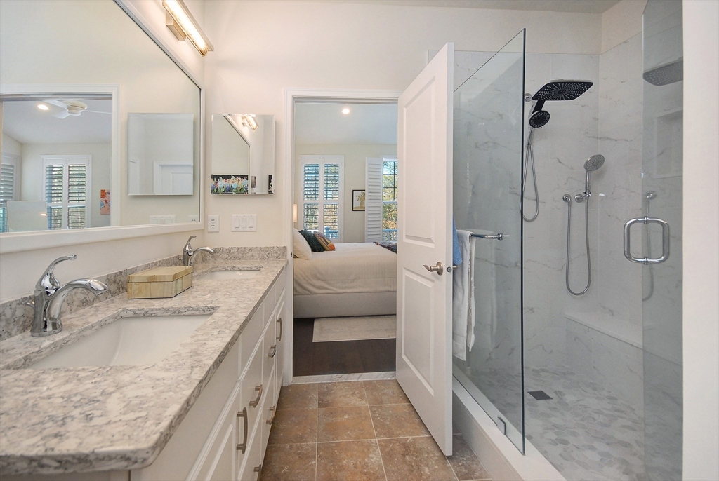 39 Ridgewood Drive, Unit 39 Stow, MA 01775 - Photo 10 of 26 a bathroom with a granite countertop sink a mirror and shower