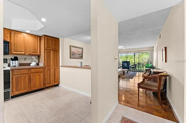 a kitchen with sink refrigerator dining table and chairs