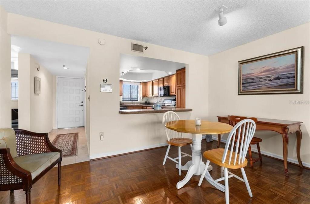 1162 Carmel Circle, Unit 440 Casselberry, FL 32707 - Photo 17 of 30 a view of a dining room with furniture and wooden floor