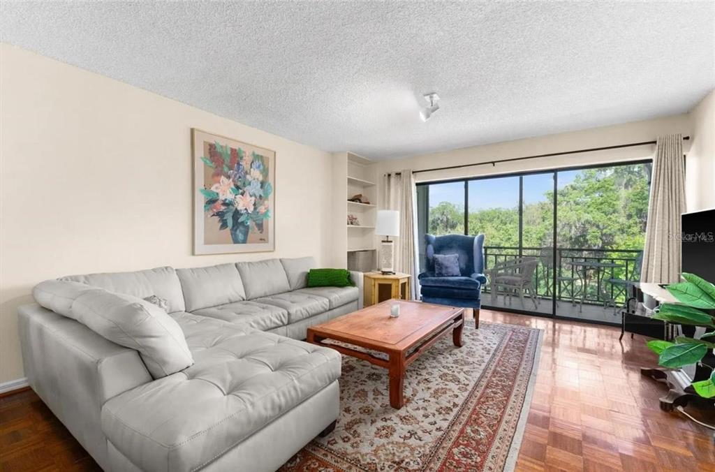1162 Carmel Circle, Unit 440 Casselberry, FL 32707 - Photo 19 of 30 a living room with furniture and a large window