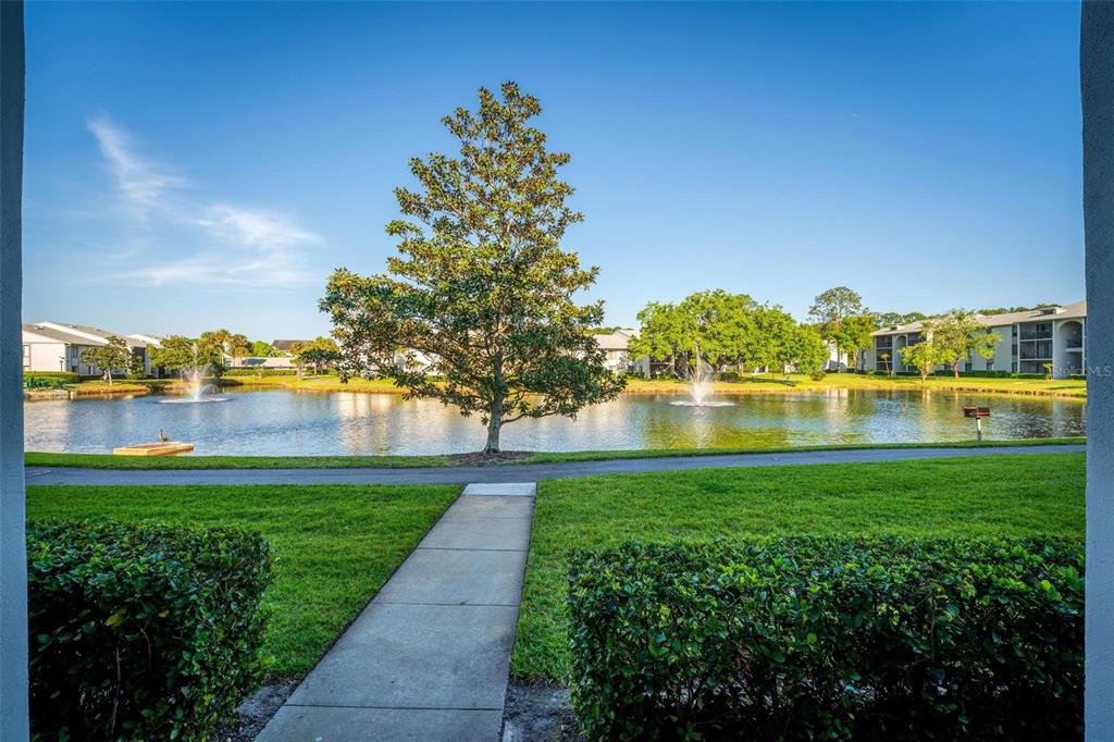 1162 Carmel Circle, Unit 440 Casselberry, FL 32707 - Photo 21 of 30 a view of a lake with a big yard