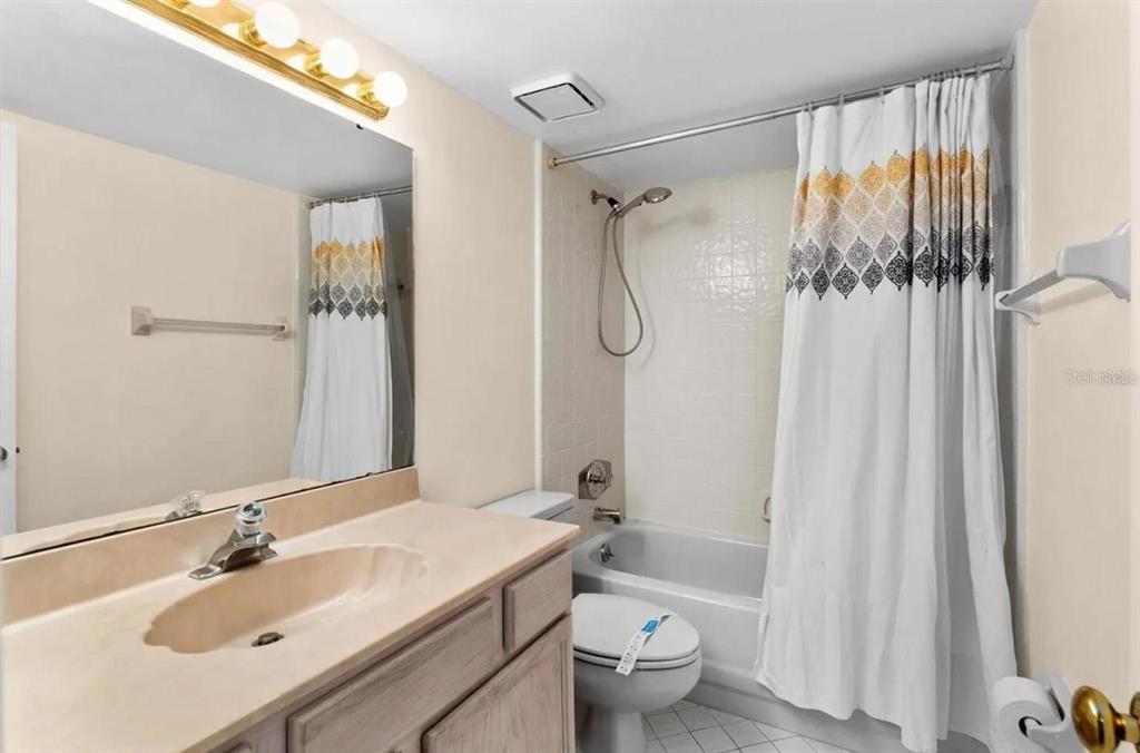 1162 Carmel Circle, Unit 440 Casselberry, FL 32707 - Photo 5 of 30 a bathroom with a granite countertop sink toilet and shower