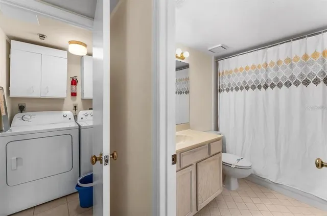 a bathroom with a sink a toilet and shower curtain