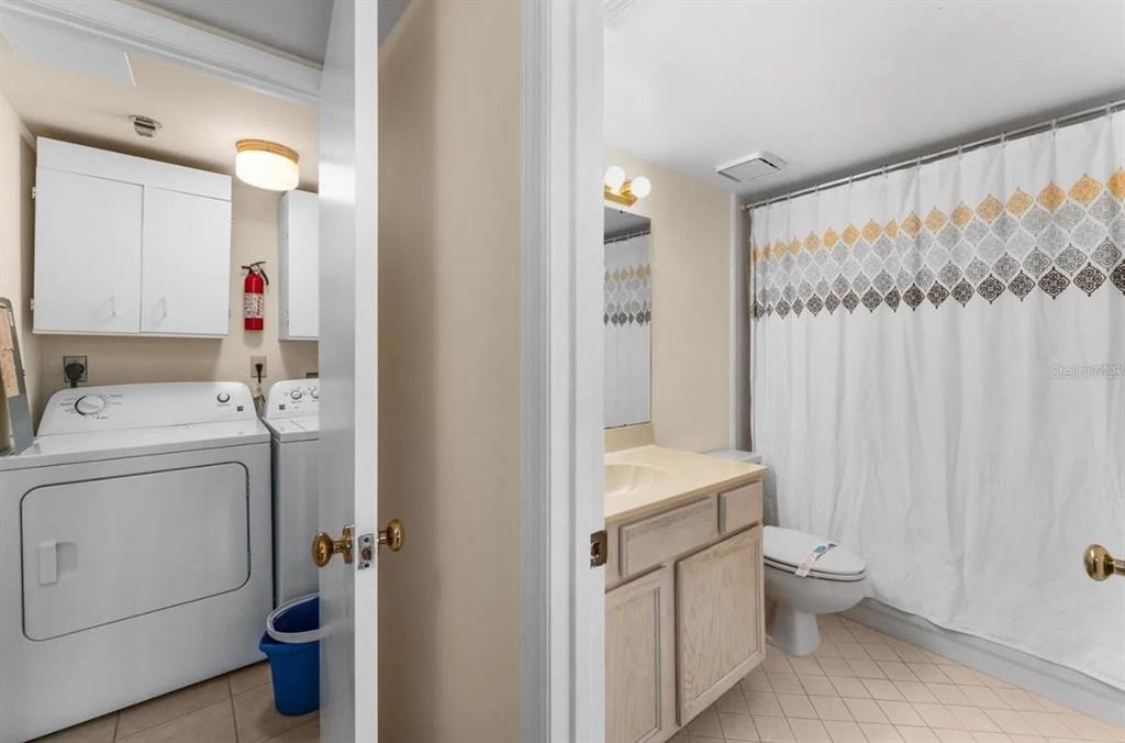 1162 Carmel Circle, Unit 440 Casselberry, FL 32707 - Photo 6 of 30 a bathroom with a sink a toilet and shower curtain