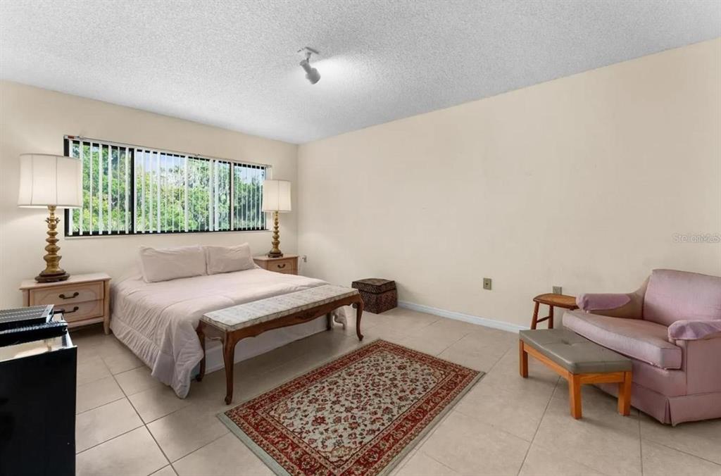1162 Carmel Circle, Unit 440 Casselberry, FL 32707 - Photo 7 of 30 a bed room with a bed and a chair