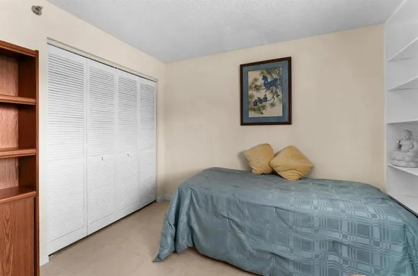 a bedroom with a bed and a cabinets