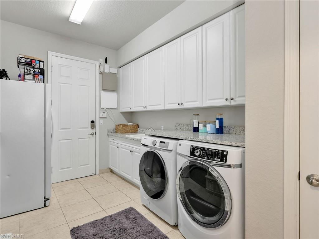 2756 Crystal Way Naples, FL 34119 - Photo 46 of 50 a utility room with sink dryer and washer