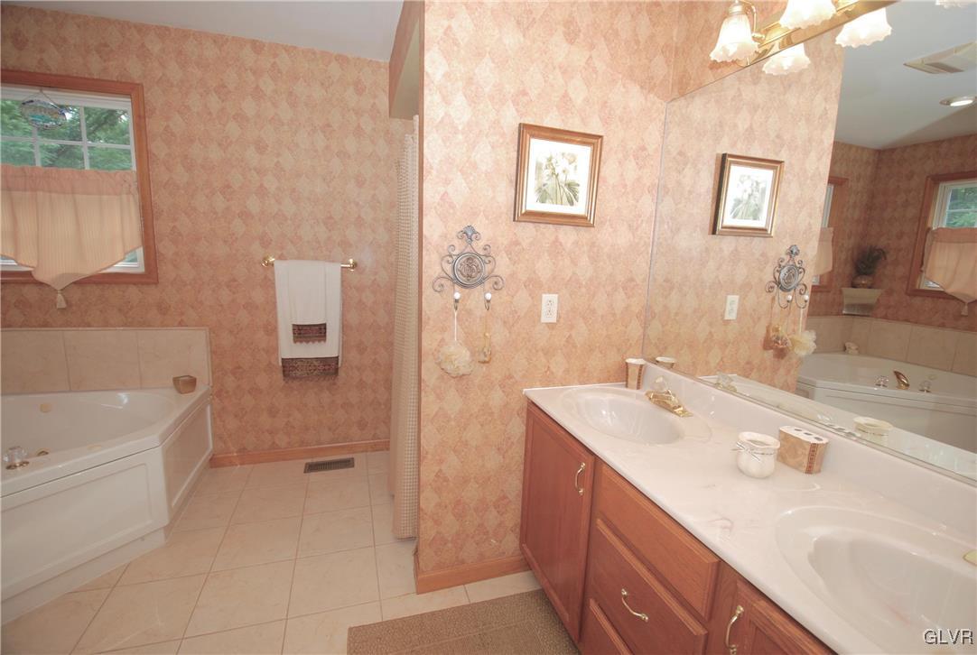 625 Turkey Ridge Road Mount Bethel, PA 18343 - Photo 21 of 43 a bathroom with a sink double vanity granite tub shower and a mirror