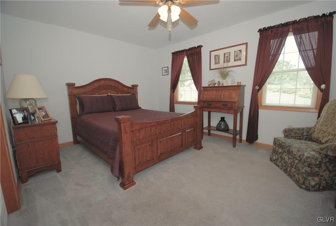 625 Turkey Ridge Road Mount Bethel, PA 18343 - Photo 24 of 43 a bedroom with a bed and a chandelier