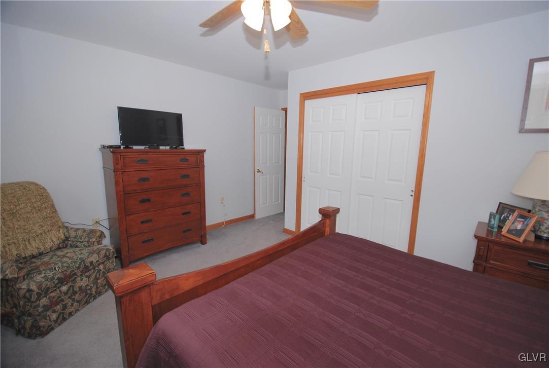 625 Turkey Ridge Road Mount Bethel, PA 18343 - Photo 25 of 43 a bedroom with a bed and a flat tv screen on dresser