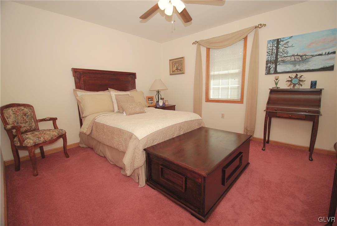 625 Turkey Ridge Road Mount Bethel, PA 18343 - Photo 28 of 43 a bedroom with a bed and a chandelier