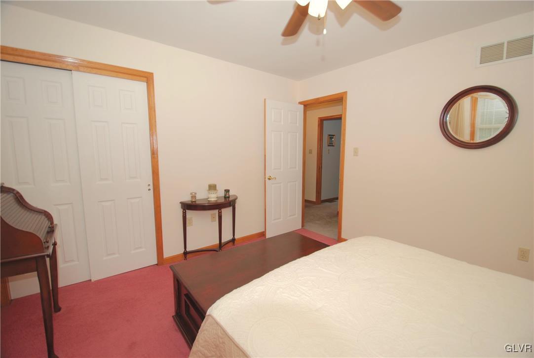625 Turkey Ridge Road Mount Bethel, PA 18343 - Photo 29 of 43 a bedroom with a bed and a chandelier