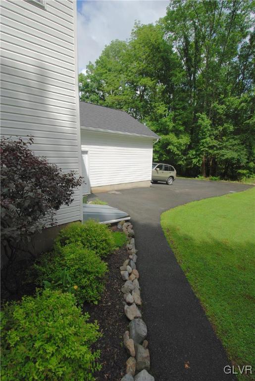 625 Turkey Ridge Road Mount Bethel, PA 18343 - Photo 36 of 43 a view of a backyard with plants and large trees