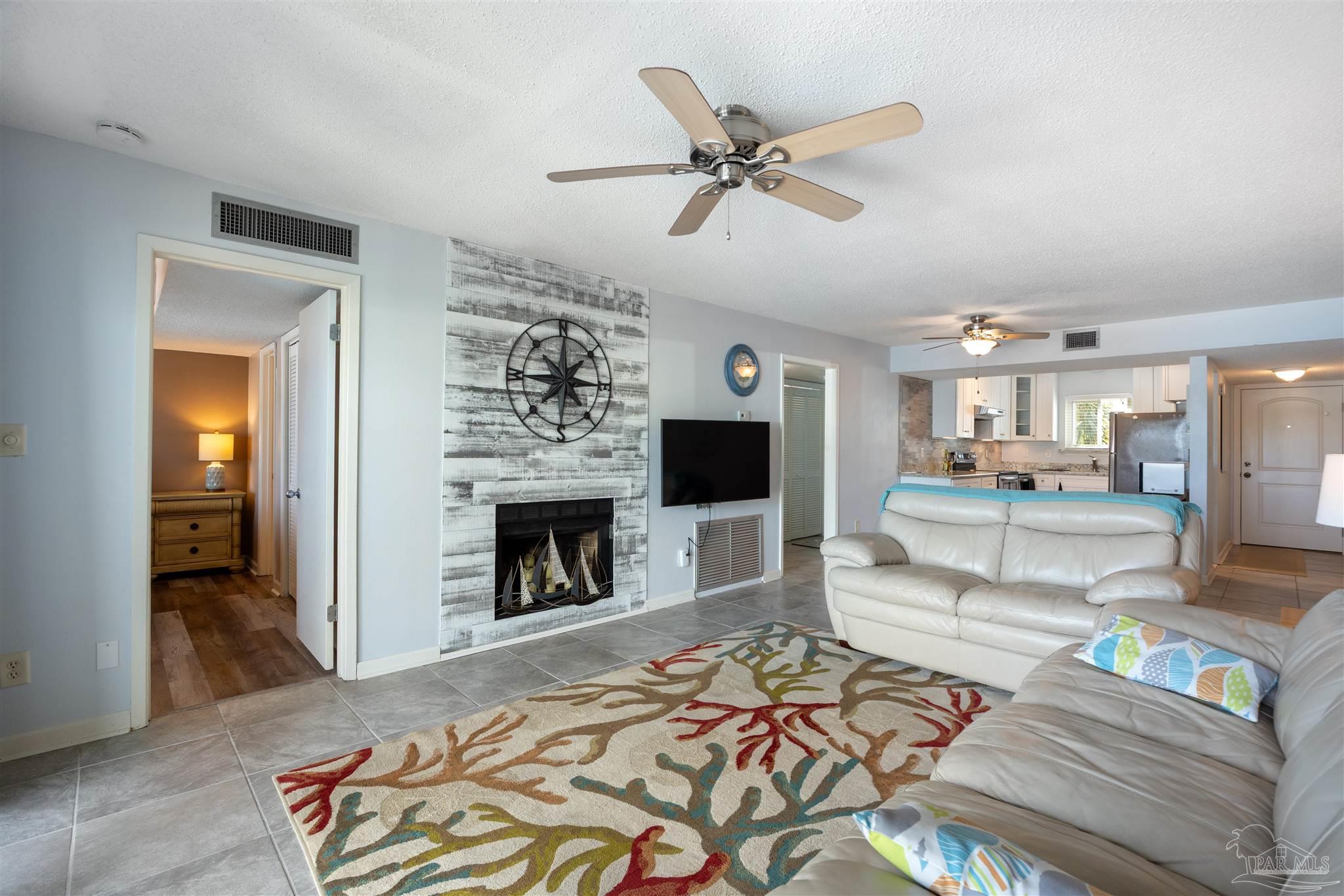 14100 River Road, Unit 228B Pensacola, FL 32507 - Photo 3 of 41 a living room with furniture and a fireplace