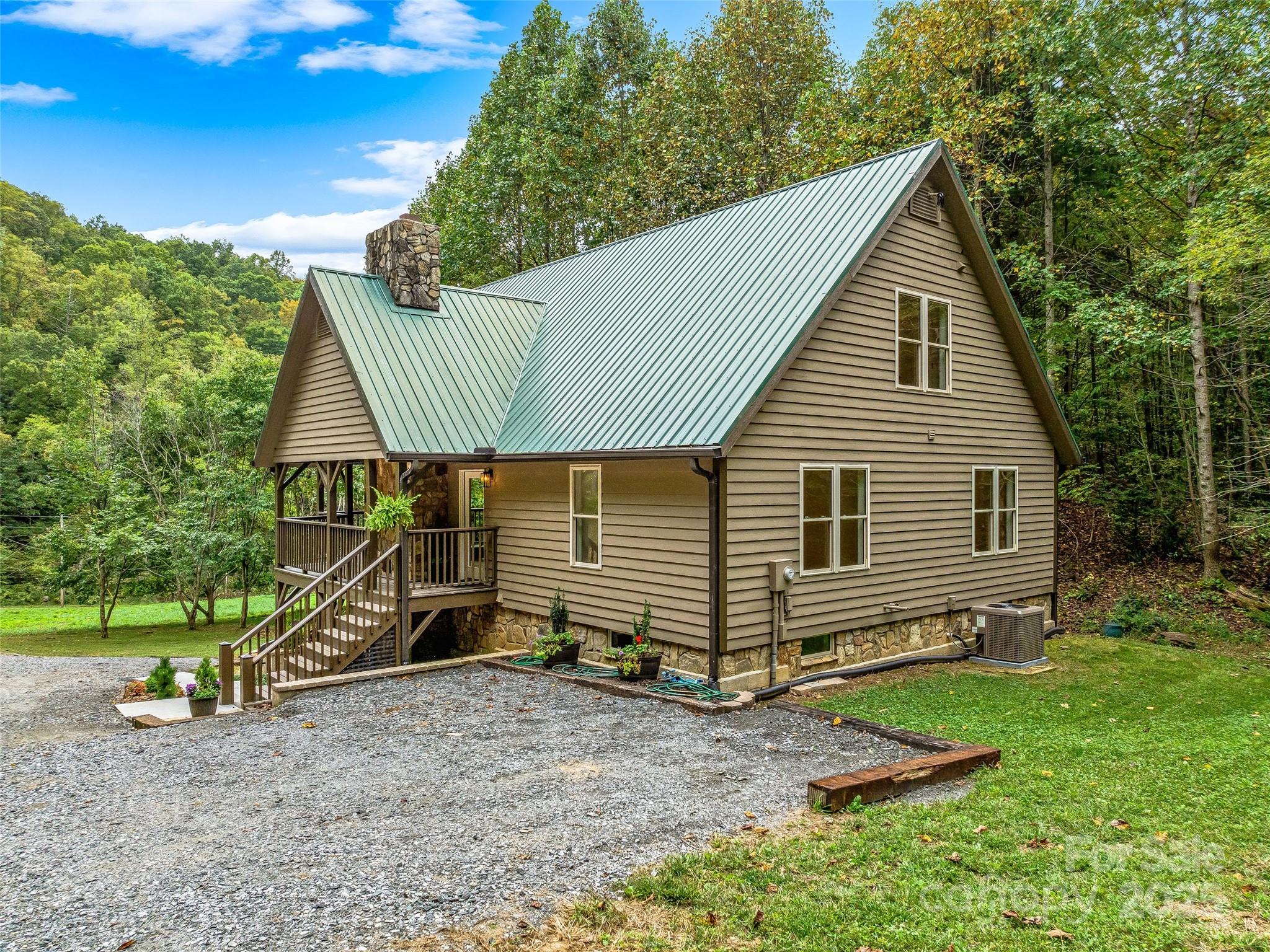 2725 Upper Brush Creek Road Marshall, NC 28753 - Photo 12 of 48 a view of a house with a yard and sitting area