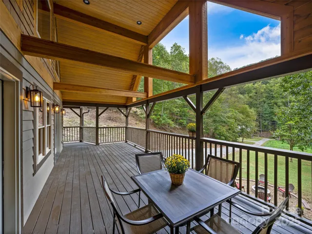 a view of balcony with wooden floor and outdoor seating