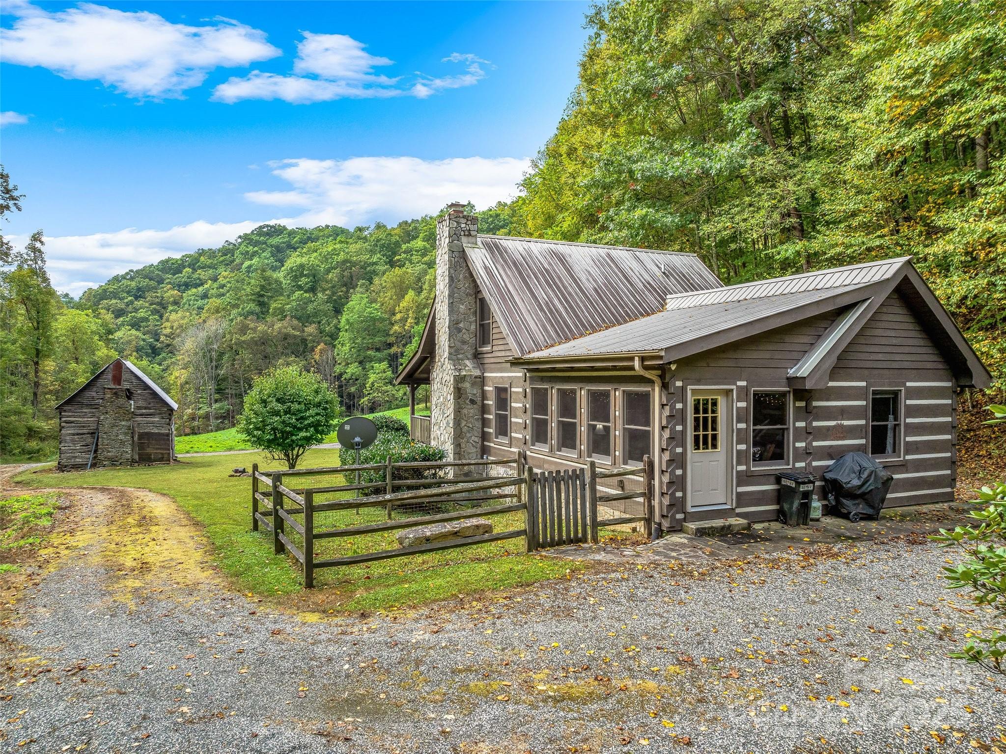 2725 Upper Brush Creek Road Marshall, NC 28753 - Photo 36 of 48 a view of a house with a yard and sitting area