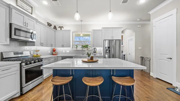 a kitchen with a sink stove and cabinets
