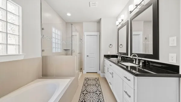 a spacious bedroom with a bed and a chandelier