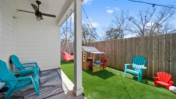 a couple of chairs sitting on a roof deck