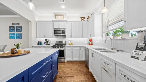 a kitchen with stainless steel appliances a refrigerator sink and microwave