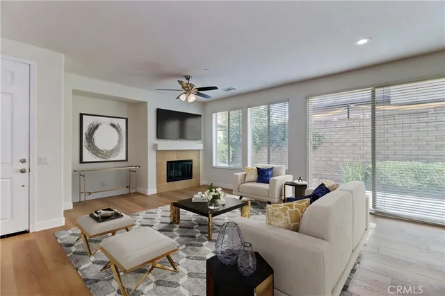 a living room with furniture fireplace and a large window