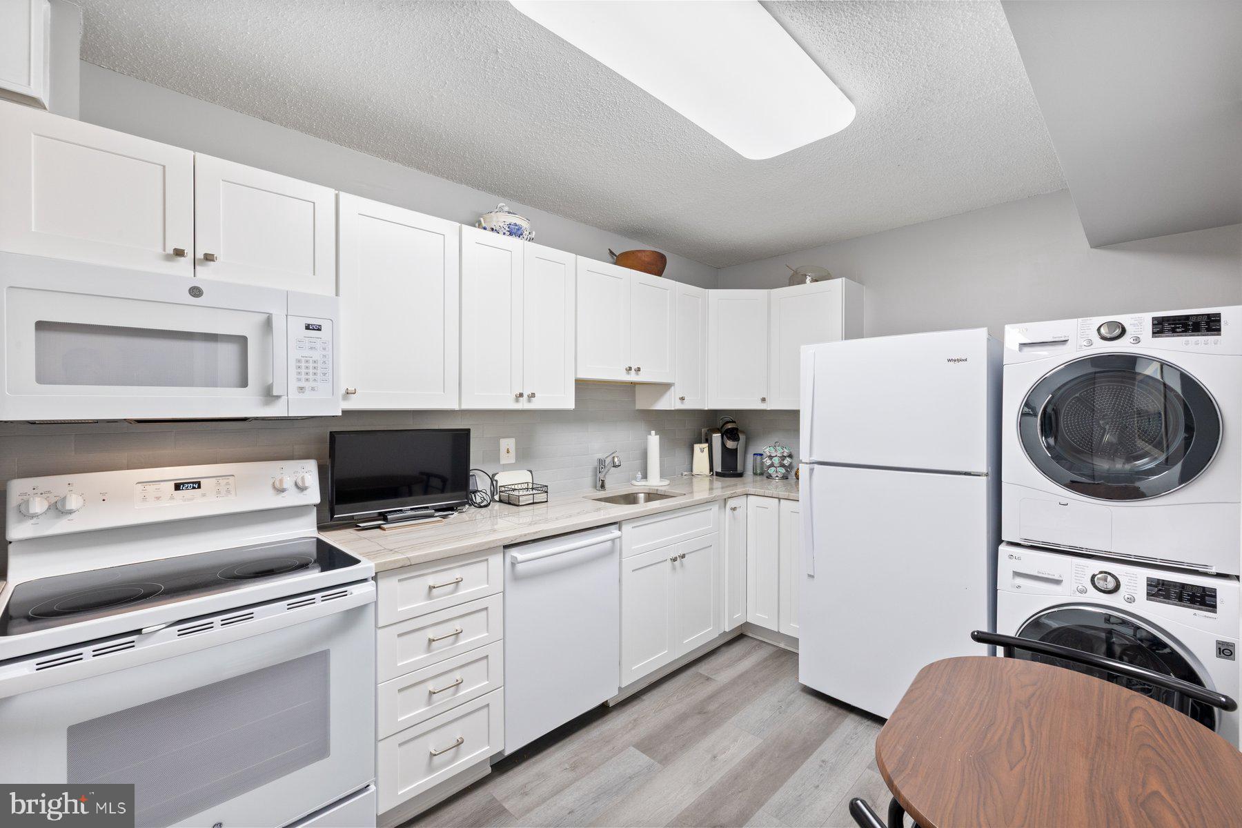 15107 Interlachen Drive, Unit 2822 Silver Spring, MD 20906 - Photo 11 of 35 a kitchen with appliances a sink and cabinets