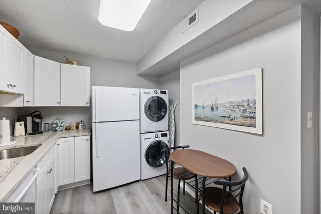a kitchen with white cabinets and white appliances