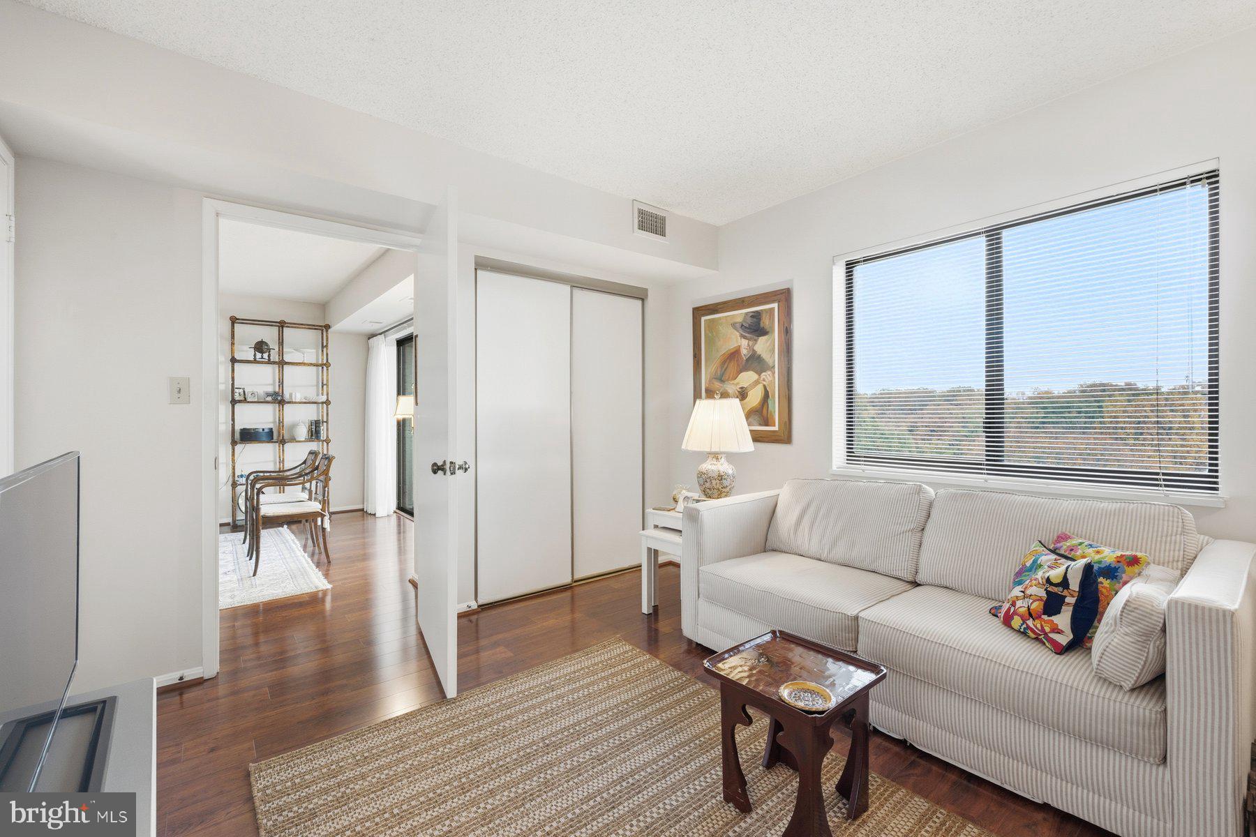15107 Interlachen Drive, Unit 2822 Silver Spring, MD 20906 - Photo 16 of 35 a living room with furniture and a large window