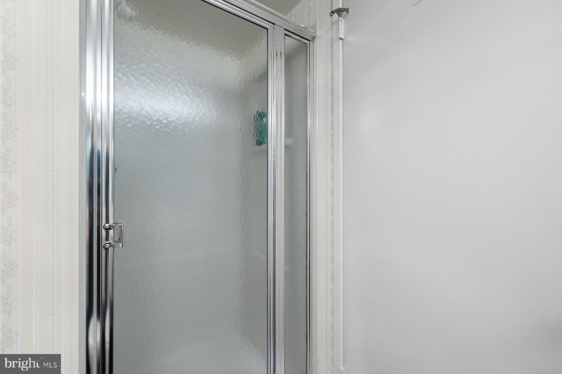 15107 Interlachen Drive, Unit 2822 Silver Spring, MD 20906 - Photo 19 of 35 a bathroom with a glass shower door