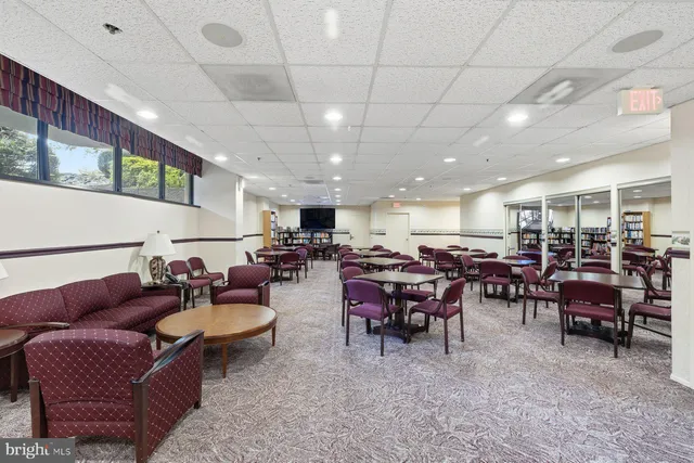 a lobby with furniture and a potted plant
