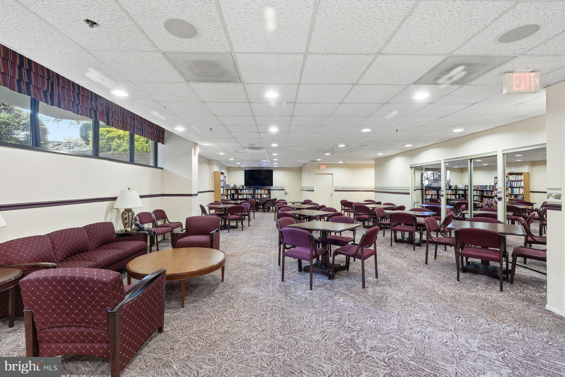 15107 Interlachen Drive, Unit 2822 Silver Spring, MD 20906 - Photo 29 of 35 a living room with lots of furniture and a large window