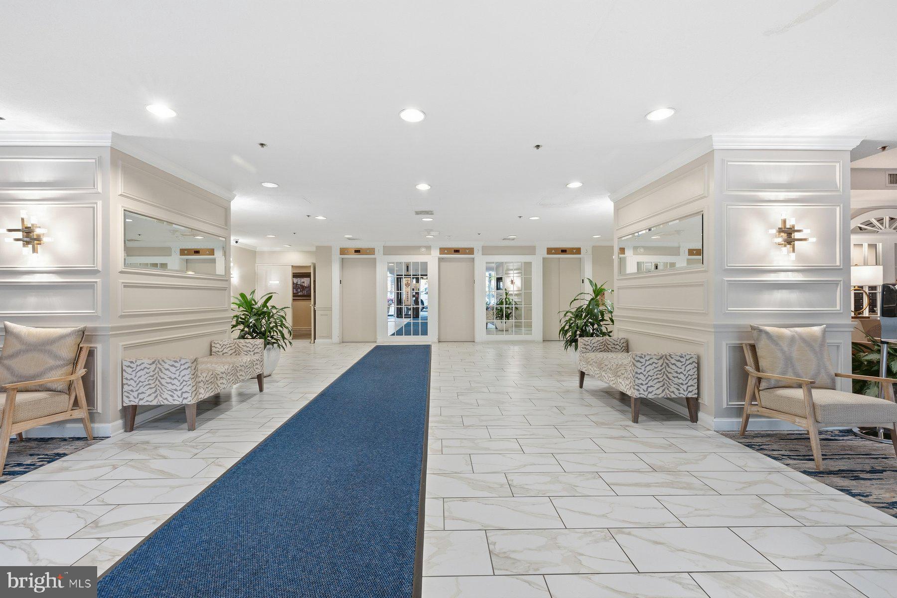 15107 Interlachen Drive, Unit 2822 Silver Spring, MD 20906 - Photo 32 of 35 a lobby with furniture and a potted plant