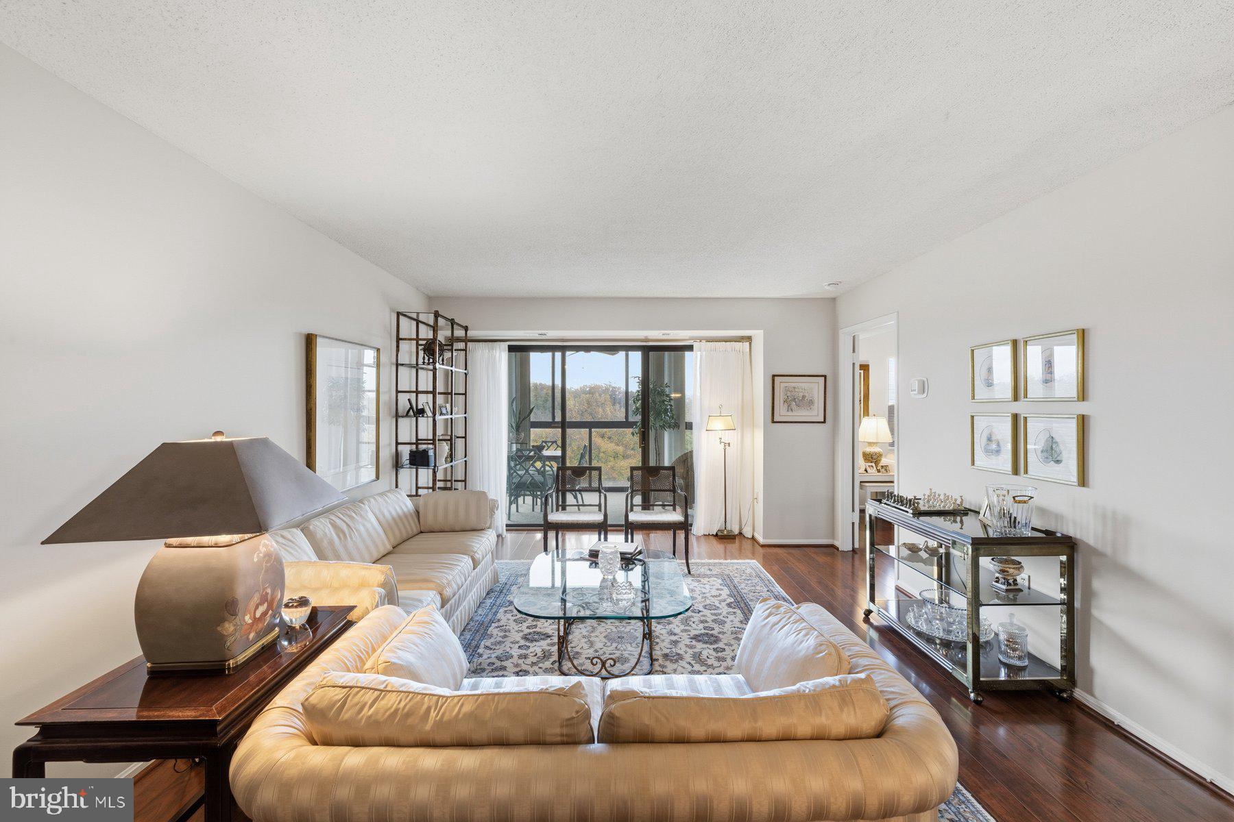15107 Interlachen Drive, Unit 2822 Silver Spring, MD 20906 - Photo 5 of 35 a living room with furniture and a table