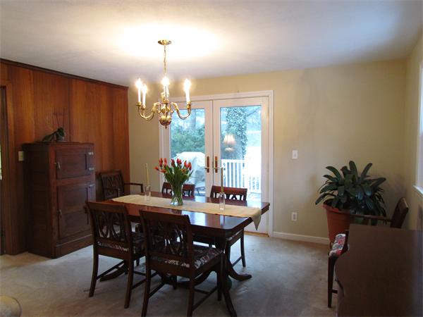 22 White Road Wayland, MA 01778 - Photo 8 of 20 a dining room with furniture potted plants and wooden floor