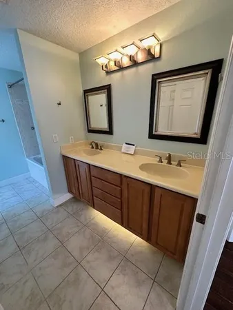 a bathroom with a double vanity sink and mirror