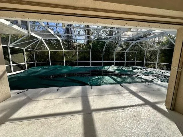a view of a backyard with table and chairs