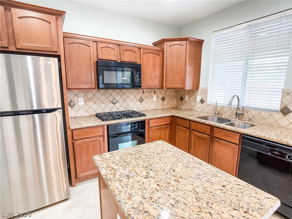 8683 Moreno Mountain Avenue Las Vegas, NV 89178 - Photo 9 of 26 A well-appointed kitchen features rich wood cabinetry and ample counter space.